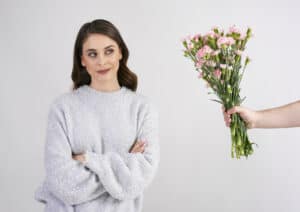 Someone giving flowers to a woman