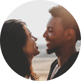 A man and a woman are looking into each other's eyes