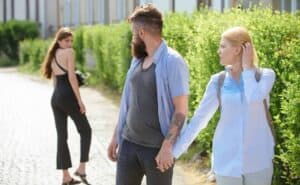 A man and a woman walking down a street