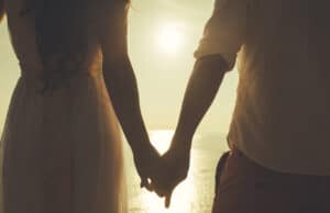 Married couple holding hands