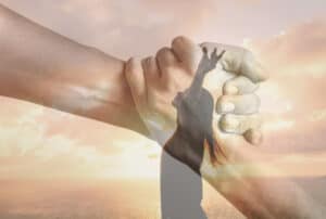 Woman meditating holding hand in hand